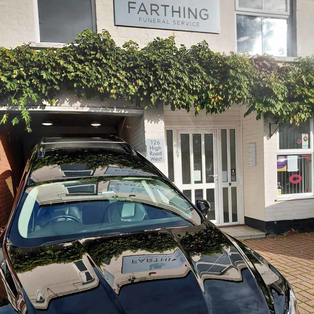 The outside of Farthing Funeral Service' Felixstowe branch with one of their cars parked in front.